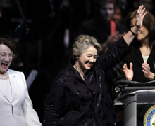 Houston Mayor Annise Parker, center, walks onto the stage with her partner, Kathy Hubbard, during her public inauguration ceremony.